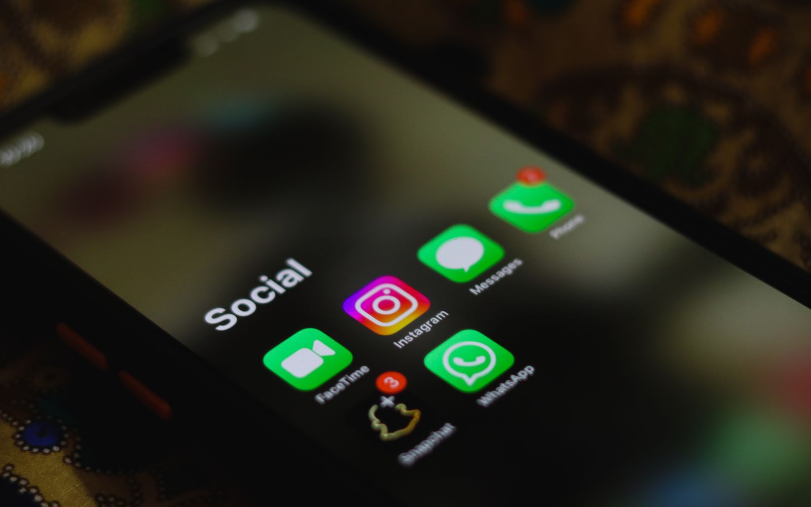 Tela de celular em close com os ícones dos aplicativos de redes sociais
