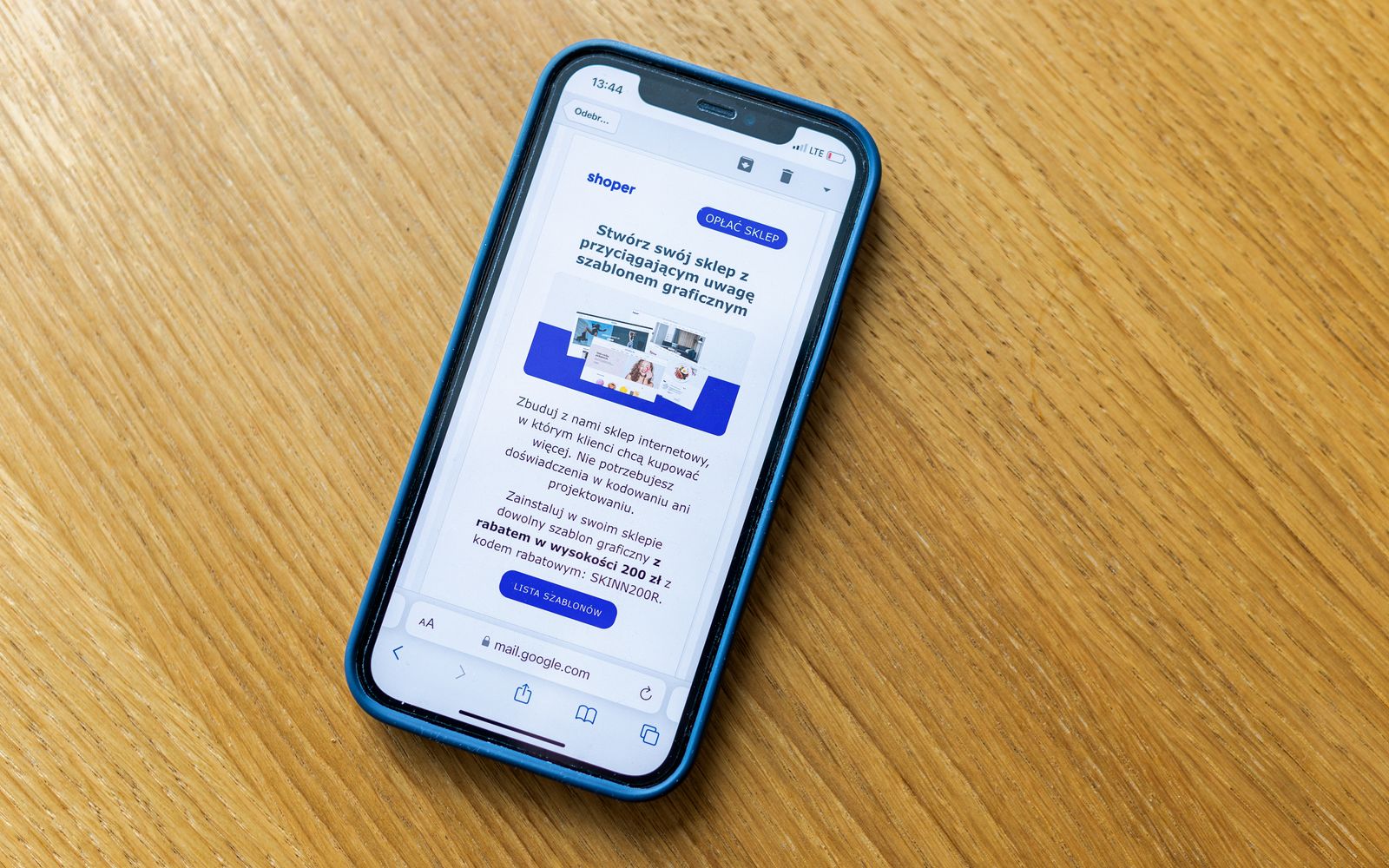 Celular sobre mesa de madeira exibindo a página de uma loja virtual