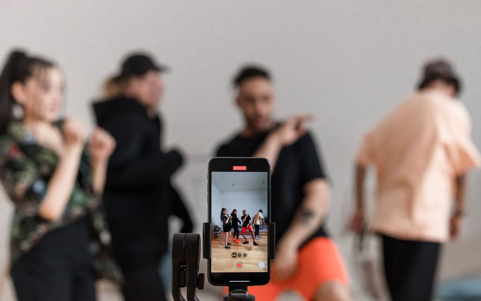 Grupo de dançarinos gravando uma performance com o celular em tripé